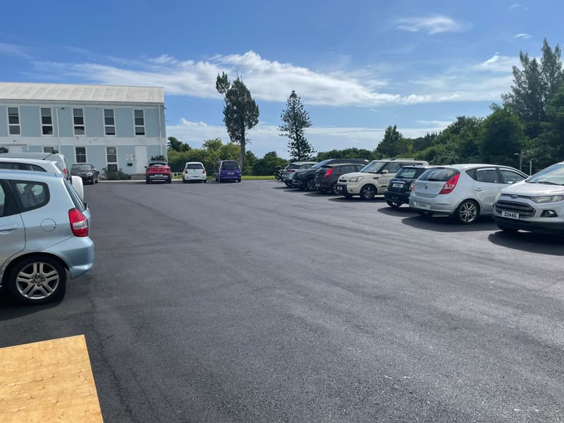Newly paved asphalt parking lot at Bermuda Broadcasting Company with cars parked