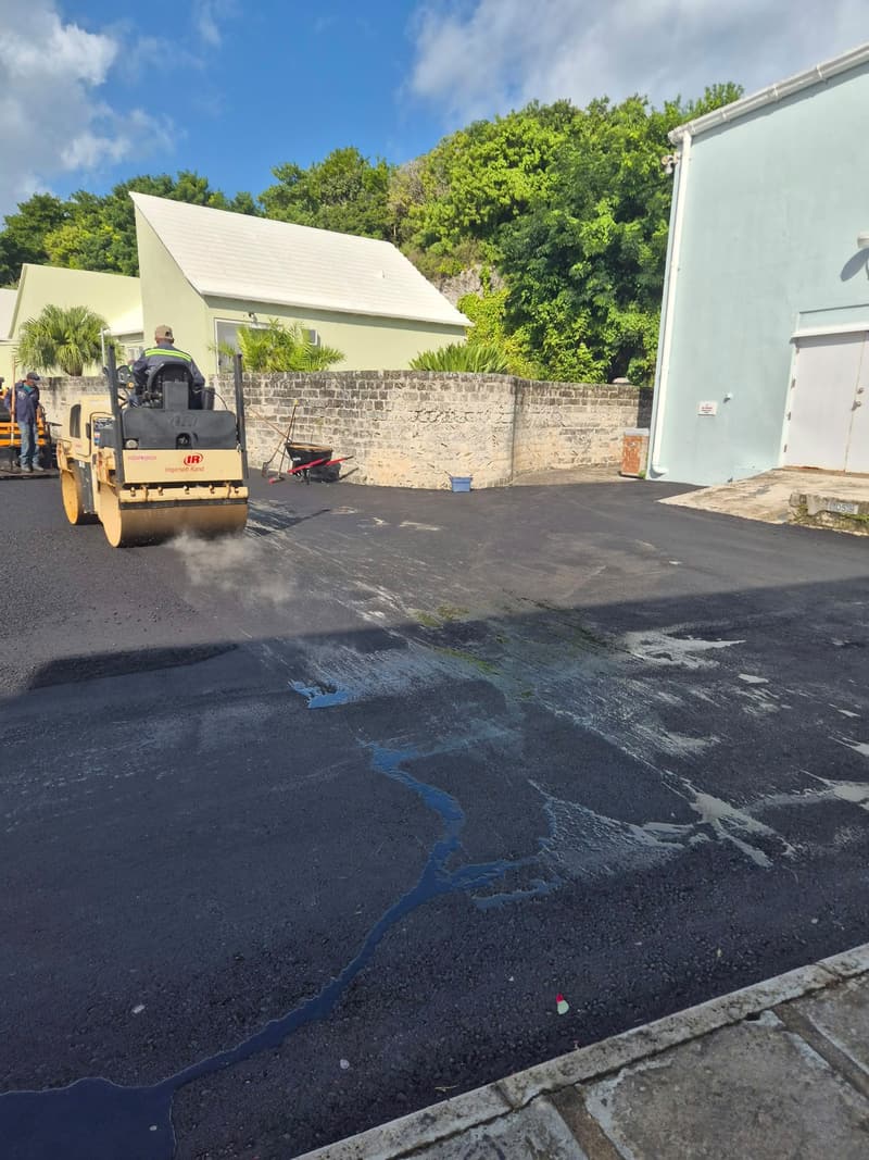 Quality Control Ltd roller compacting fresh asphalt in the Bermuda Broadcasting Company parking lot