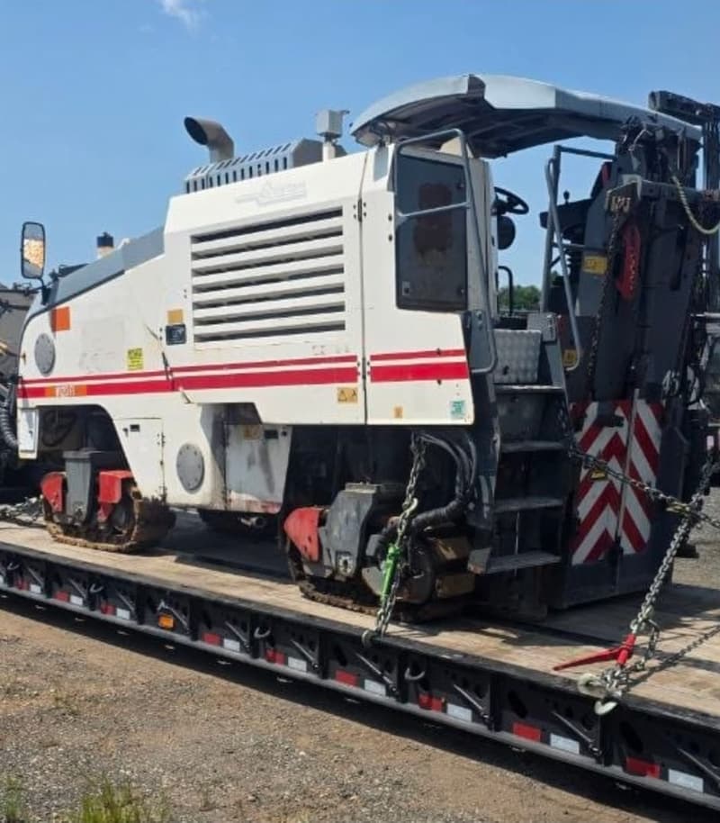 Quality Control asphalt milling machine secured on a low-loader trailer