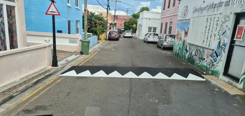 Asphalt speed bump with white markings on a Bermuda street
